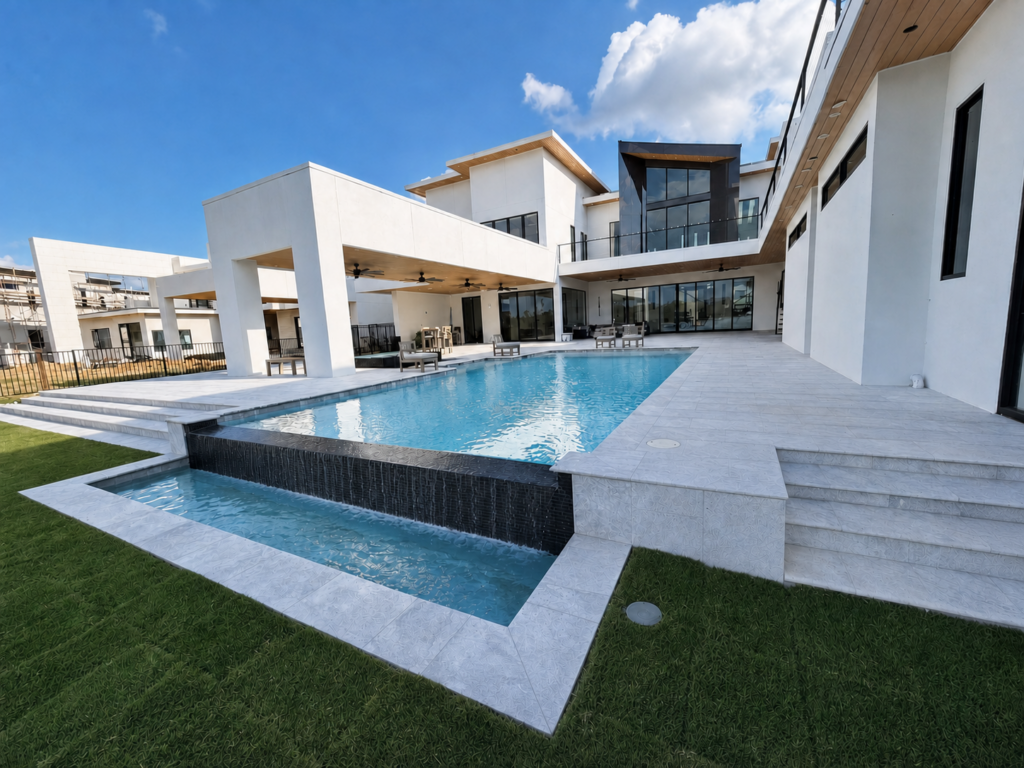 Modern infinity edge pool with waterfall spillway and contemporary home in The Woodlands, Texas