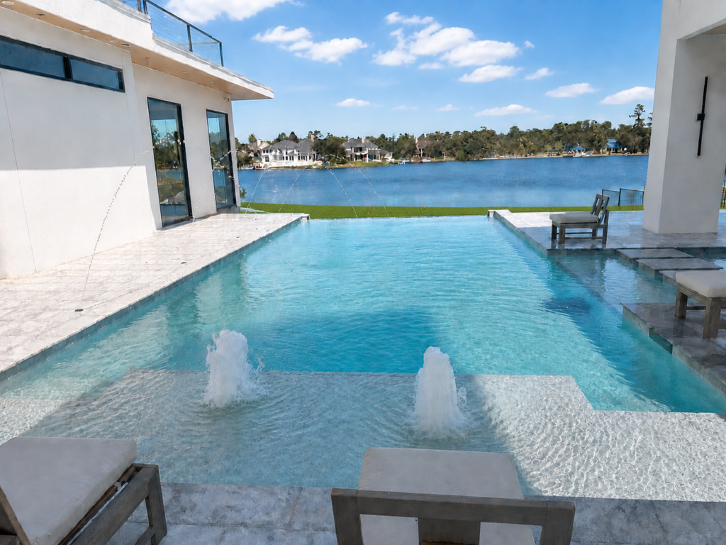 Custom pool with water jets, infinity edge, and lake view in The Woodlands, Texas